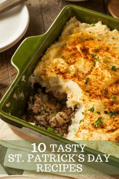 a green casserole dish filled with mashed potatoes and meat