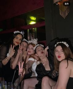 a group of women posing for the camera with their hands up in front of them