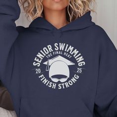 a woman wearing a navy hoodie that says senior swimming finish strong