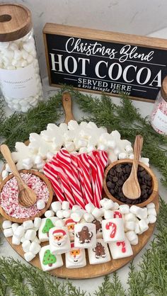 a platter filled with marshmallows, chocolate and hot cocoa on top of a table