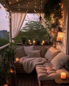 a couch sitting on top of a wooden floor next to a window filled with candles