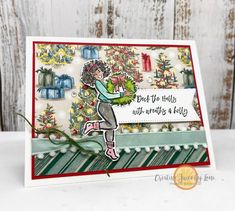 a handmade christmas card with a girl holding a wreath and saying, don't let the holly