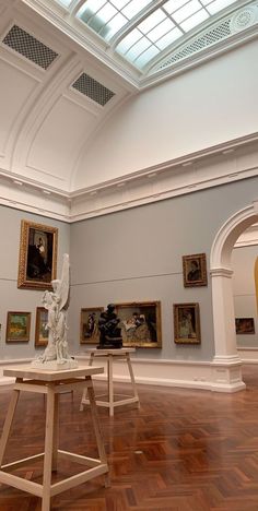 an art gallery with paintings and sculptures on the walls