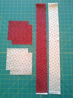 two pieces of fabric sitting on top of a cutting board next to a knife and ruler