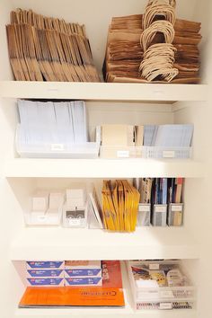 the shelves are filled with many different types of books and office supplies, including file folders