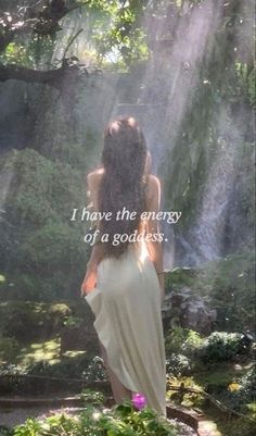 a woman standing in front of a waterfall with the words i have the energy of a godless