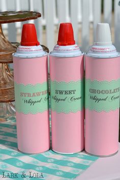 three pink spray bottles sitting on top of a table