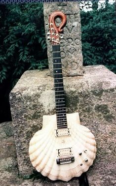 an electric guitar sitting on top of a rock