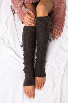 Long cable knit tie leg warmers. These yummy, thick-knitted leg warmers are perfect for everything from lounging by the fire on a cozy afternoon to running errands tucked into your new boots. DETAILS: Cable Knit Pattern One Size fits most Removable Ties Leg Warmer Measures Approximately 25" Fall Cable Knit Knee-high Socks, Cozy Thigh High Cable Knit Leg Warmers, Knee-high Cable Knit Winter Socks, Cozy Cable Knit Socks For Winter, Cozy Cable Knit Winter Socks, Cozy Comfortable Knee-high Socks For Fall, Comfortable Knee-high Leg Warmers For Fall, Cozy Brown Leg Warmers For Fall, Cozy Cable Knit Knee-high Socks For Fall