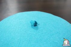 a piece of blue cake sitting on top of a table