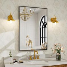 a bathroom with a sink, mirror and gold faucet lights on the wall