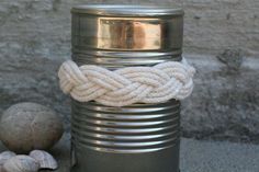 there are three different types of tin cans with rope wrapped around the top and bottom