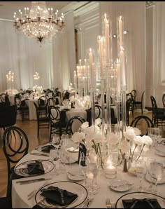 an elegant table setting with candles and flowers