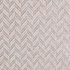 an upholstered white and beige fabric textured with zigzag lines