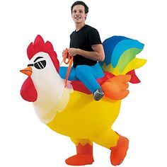 a man is riding on an inflatable chicken