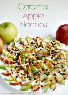 an apple salad on a white plate next to two apples