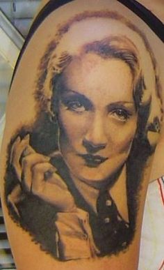 a woman's arm with a tattoo on it that has an image of marilyn monroe