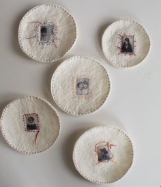 four embroidered coasters with pictures on them