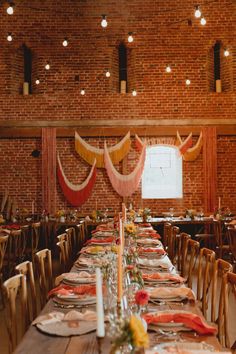 a long table set up with place settings and decorations for a wedding or other function