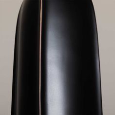 the back end of a black chair with metal piping on it's sides