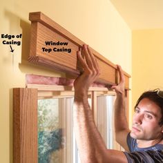 a man is working on a window with the words windows top casing above him