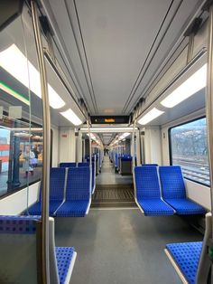 the inside of a train with blue seats