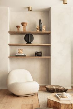 a white chair and some shelves in a room