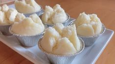 small tins filled with food sitting on top of a white plate