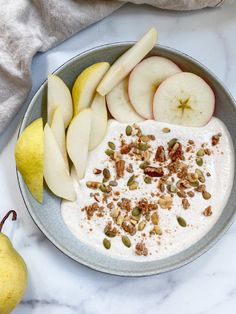 a bowl filled with yogurt, apples and granola