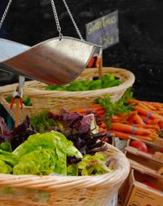 some baskets filled with different types of vegetables