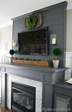 a fireplace mantel with a tv above it