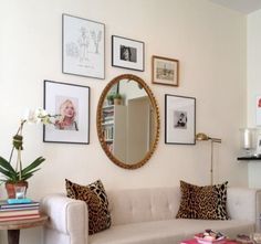 a living room filled with lots of furniture and pictures on the wall above it's coffee table