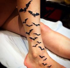 a woman's leg with bats on it