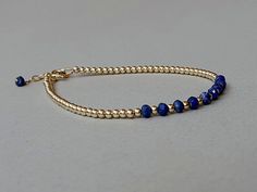 A gold, elegant bracelet with genuine lapis lazuli rondelles Please measure tightly your wrist's circumference, using a ribbon or something similar, and then measuring the ribbon with a ruler. When ordering, please select the actual wrist size, not the size of the bracelet. I will make the bracelet fit your wrist, by adding approx 0.6 inch to the circumference. The bracelet was set up using  genuine lapis lazuli faceted rondelles and gold filled findings and it is adjustable (it has an adjusting chain). Available also with sterling silver findings. Lapis Lazuli encourages self-awareness and taking charge of your own life. It helps us express ourselves safely and empowering without holding back, and brings the qualities of honesty, compassion and integrity to the wearer.  At the same time, Elegant Adjustable Lapis Lazuli Beaded Bracelet, Adjustable Elegant Lapis Lazuli Bracelets, Adjustable Lapis Lazuli Jewelry With Faceted Beads, Everyday Lapis Lazuli Jewelry With Gemstone Beads, Hand-strung Gold Lapis Lazuli Bracelets, Minimalist Adjustable Lapis Lazuli Jewelry, Adjustable Minimalist Lapis Lazuli Jewelry, Dainty Blue Rondelle Jewelry, Gold Beaded Lapis Lazuli Bracelets