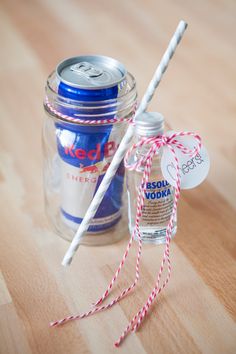 a mason jar filled with soda and two straws next to a red white and blue striped twine