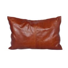 a brown leather pillow on a white background