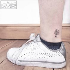 a small tree tattoo on the ankle