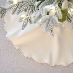 a christmas tree is in the center of a white plate with silver trimmings