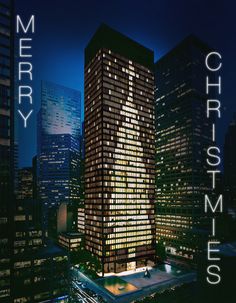 a very tall building with the words merry christmas on it's side in front of some skyscrapers