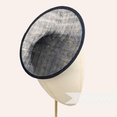 This rounded scoop fascinator hat base is made from a triple layer of black stiffened sinamay millinery fabric and is ideal for making an instant fascinator! The scooped center of the disc allows you to get creative by positioning it at different angles on the head.  Just add elastic, headband or comb for securing to the head (not included but available in our shop!) Measurements: Diameter: 21cm (8.2 inches) Height: 2cm (0.7 inches)  Available in several colours from our millinery supply store h Sinamay Fascinator, Blank Hats, Millinery Supplies, Hat Base, Fascinator Hat, Millinery Hats, Elastic Headband, French Navy, Fascinator Hats