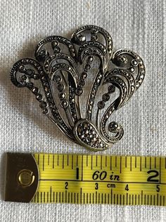 This is a Vintage Early 20th century brooch that belonged to my grandmother.  It hails from Italy. It is not silver. Victorian Silver Brooch For Evening, Ornate Silver Brooches For Evening, Silver Costume Jewelry Brooches For Formal Occasions, Silver Costume Jewelry Brooch For Formal Occasions, Silver Victorian Brooches For Vintage Events, Victorian Silver Brooch For Vintage Events, Antique Silver Brooches For Formal Occasions, Silver Victorian Brooch For Vintage Events, Antique Silver Brooch For Formal Occasions