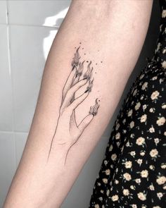 a woman's arm with a flower tattoo on it