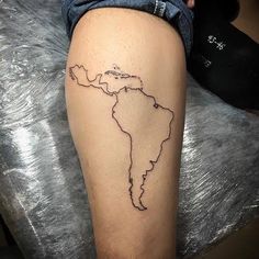 a person with a tattoo on their leg that has the outline of africa in it