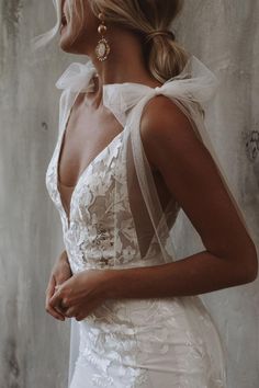 a woman wearing a white dress and veil