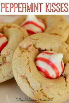 peppermin kisses cookies with white and red candy canes in the middle on a plate