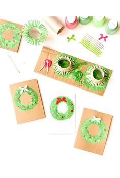 some crafting supplies are laid out on the table to be used for christmas wreaths