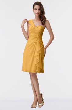 a woman in a yellow dress posing for the camera