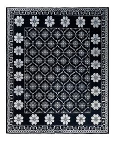 a black and white rug with flowers on it