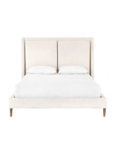 a bed with white linens and pillows on it's headboard, in front of a white background