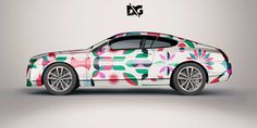 a car with colorful flowers painted on it's side and the word dg above it